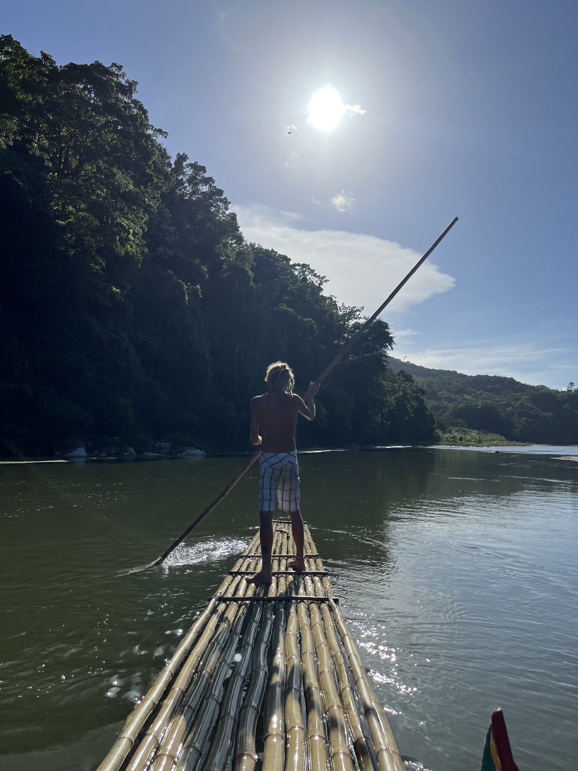 Captain Robbie poling a bamboo raft on Jamaica's Rio Grande